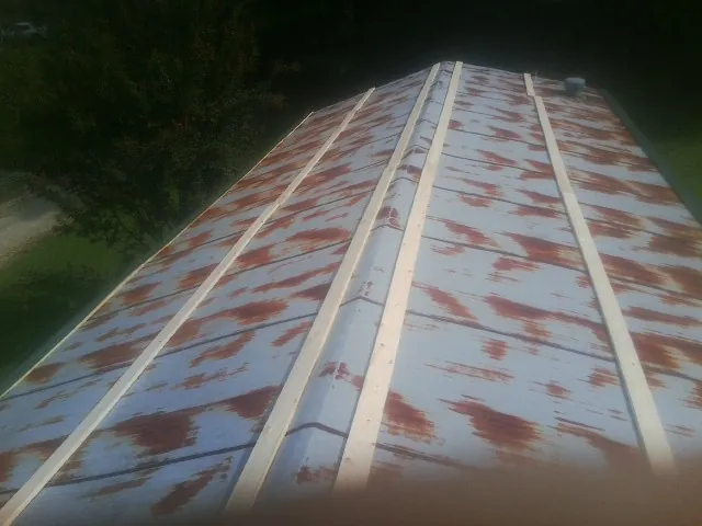 Rusted metal roof panels with new wood purlins before replacement — Storm Damage Roof Repair in Clarks Summit by Roofing Brothers