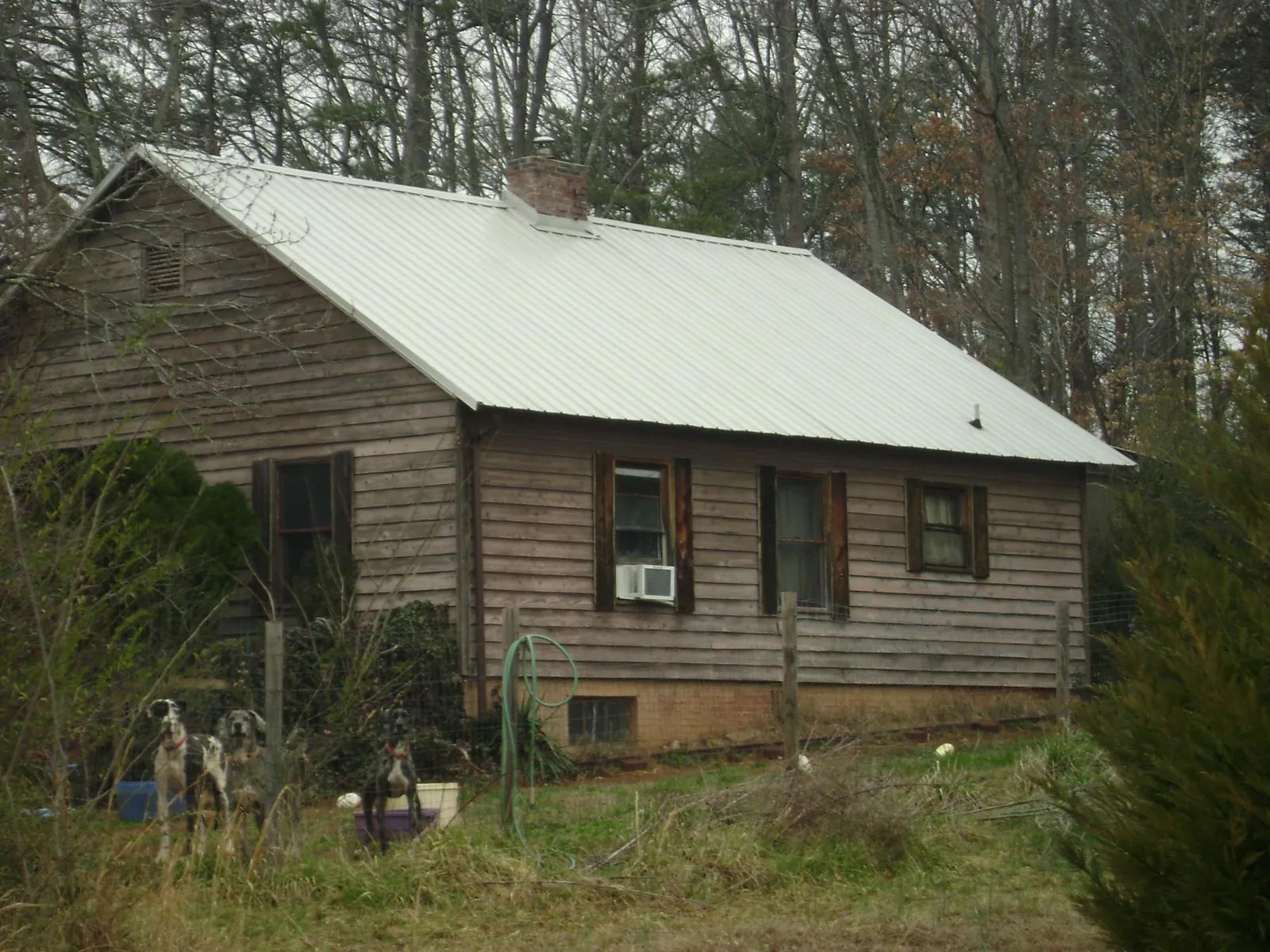 White metal roof on an old wood sided farmhouse, from a Metal Roof Installation job in Clarks Summit
